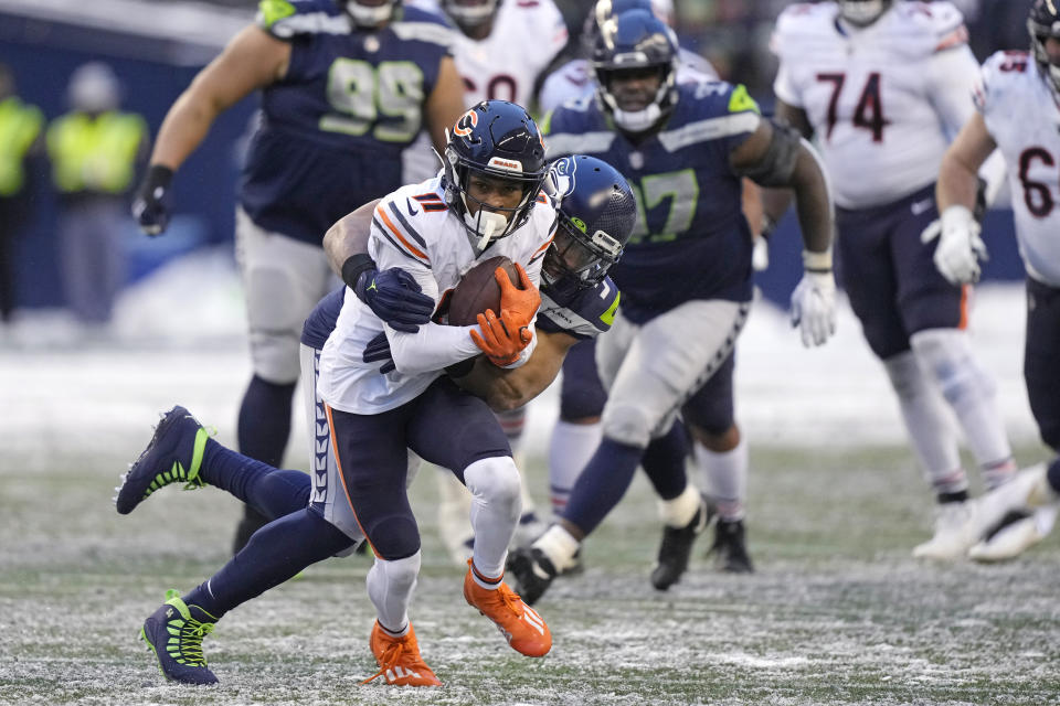 Chicago Bears wide receiver Darnell Mooney (11) is brought down by Seattle Seahawks middle linebacker Bobby Wagner during the second half of an NFL football game, Sunday, Dec. 26, 2021, in Seattle. (AP Photo/Stephen Brashear)