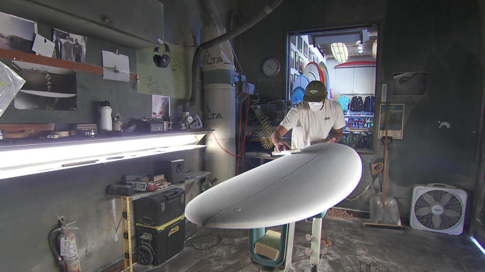 Gary Larson handcrafts a surfboard.  / Credit: CBS News