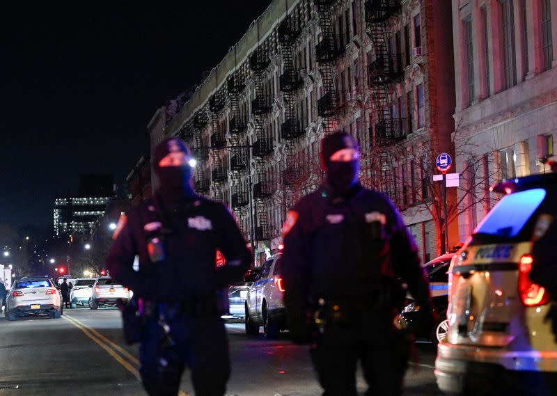 Emergency personnel respond at the scene where NYPD officers were shot while responding to a domestic violence call