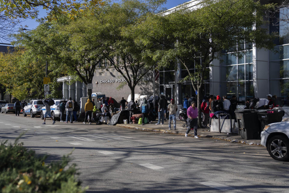 Migrants are camped outside of the 1st District police station Saturday, Oct. 7, 2023, in Chicago. (AP Photo/Erin Hooley)