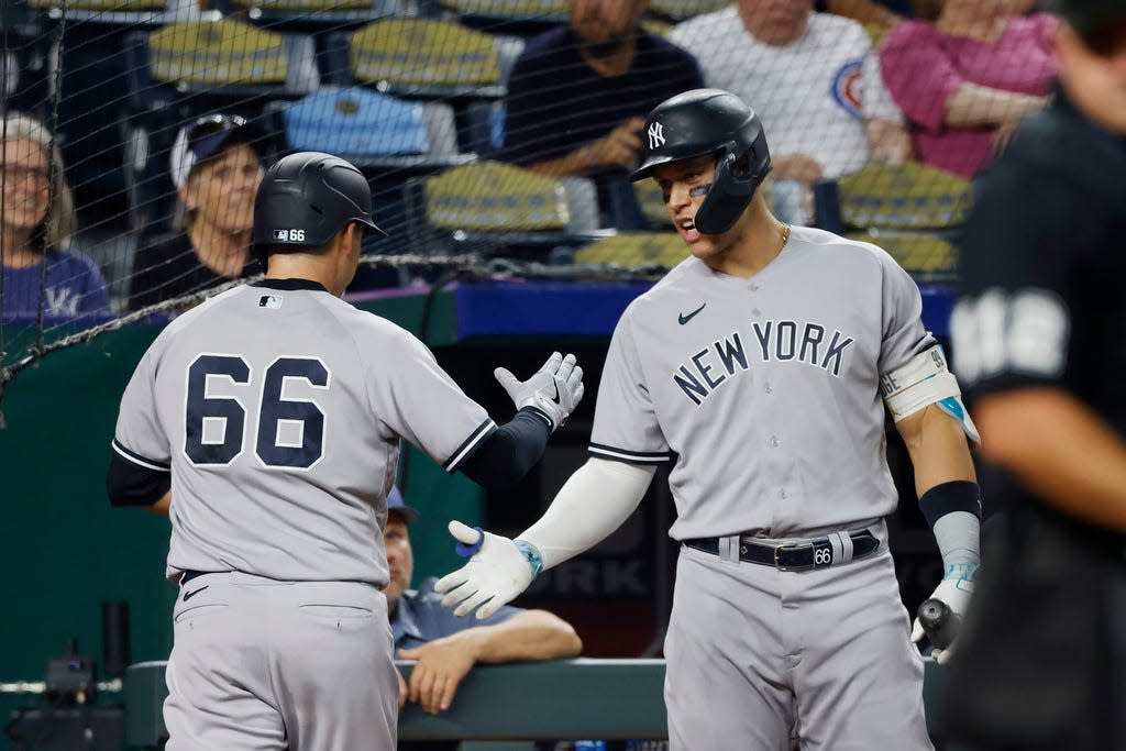 New York Yankees' Kyle Higashioka (66) is congratulated by Aaron Judge, right, after scoring the go-ahead run off a single by  Estevan Florial during the sixth inning of a baseball game against the Kansas City Royals in Kansas City, Mo., Saturday, Sept. 30, 2023. (AP Photo/Colin E. Braley)