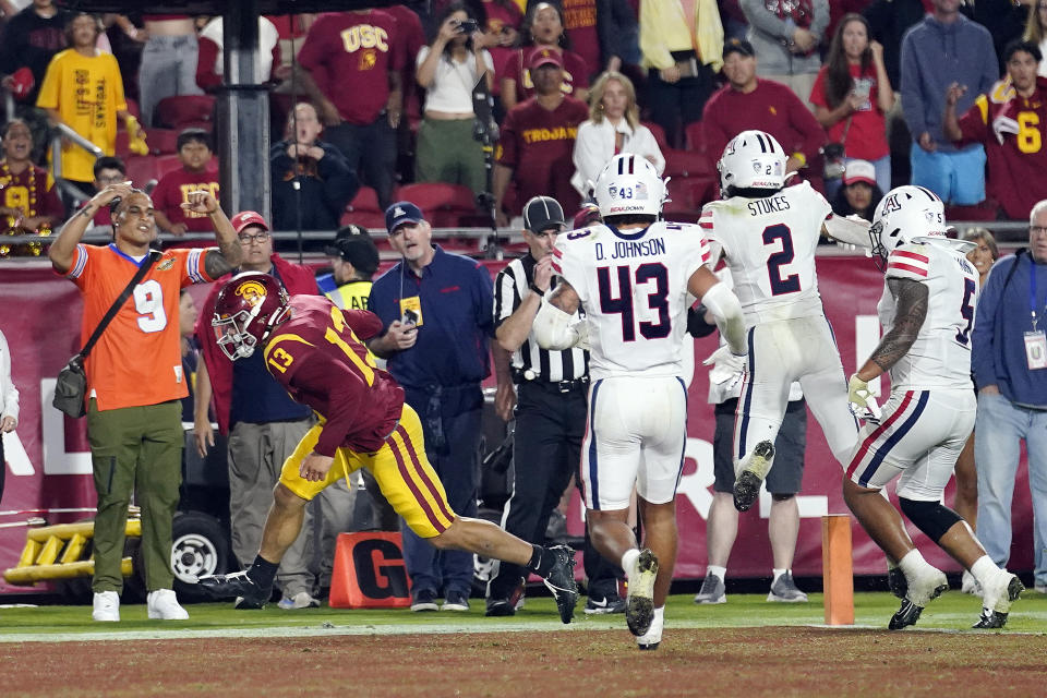 Southern California quarterback Caleb Williams (13) scores a two-point conversion to give Southern California the lead during overtime of an NCAA college football game against Arizona Saturday, Oct. 7, 2023, in Los Angeles. (AP Photo/Marcio Jose Sanchez)