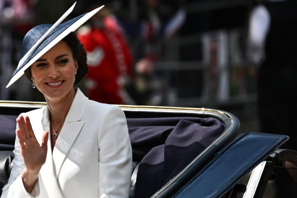 <p>The Duchess of Cambridge waves at spectators as she arrived in the top carriage with Camilla and her children, Prince George, Prince Louis and Princess Charlotte. </p>