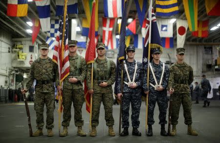 A flag party of U.S. Marines and Navy personnel take part in a ceremony marking the start of Talisman Saber 2017, a biennial joint military exercise between the United States and Australia aboard the USS Bonhomme Richard amphibious assault ship on the the Pacific Ocean off the coast of Sydney, Australia, June 29, 2017. REUTERS/Jason Reed