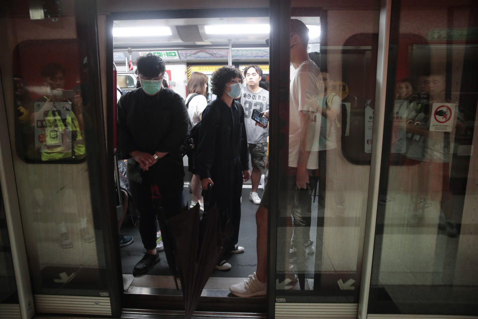 Protesters wearing masks blocked train door at a subway station in Hong Kong, on Monday, Sept. 2, 2019. Hong Kong has been the scene of tense anti-government protests for nearly three months. The demonstrations began in response to a proposed extradition law and have expanded to include other grievances and demands for democracy in the semiautonomous Chinese territory. (AP Photo/Jae C. Hong)