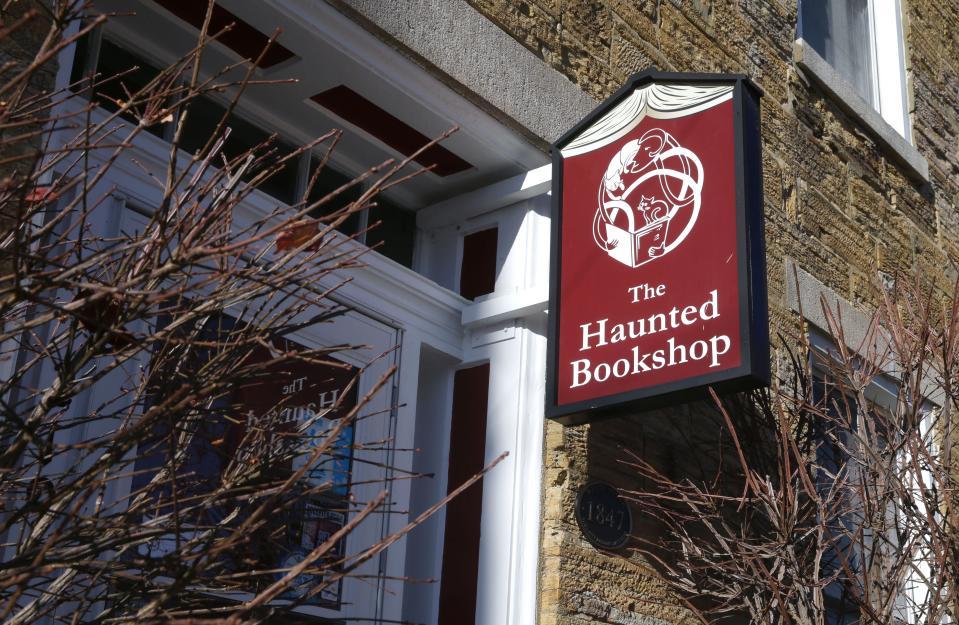 A detail photograph of The Haunted Bookshop’s sign is pictured Monday, Dec. 18, 2023 in Iowa City, Iowa.