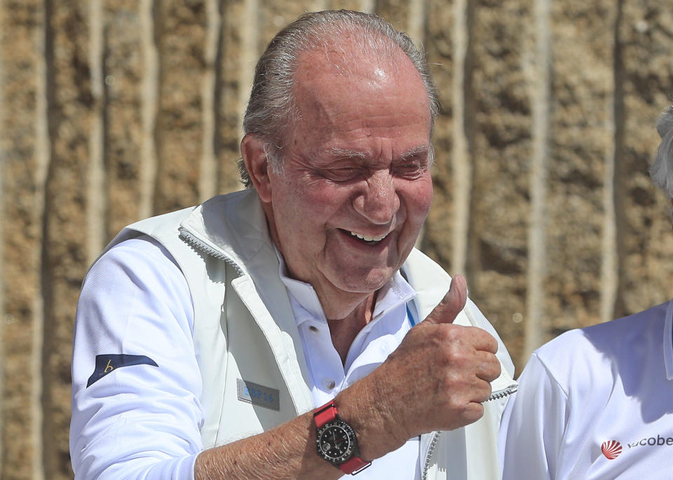 Spain's former King Juan Carlos, 2nd from right, gives the thumbs-up before a reception at a nautical club prior to a yachting event in Sanxenxo, north western Spain, Friday, May 20, 2022. Spain's former King has returned to Spain for his first visit since leaving nearly two years ago amid a cloud of financial scandals. (AP Photo/Lalo R. Villar)