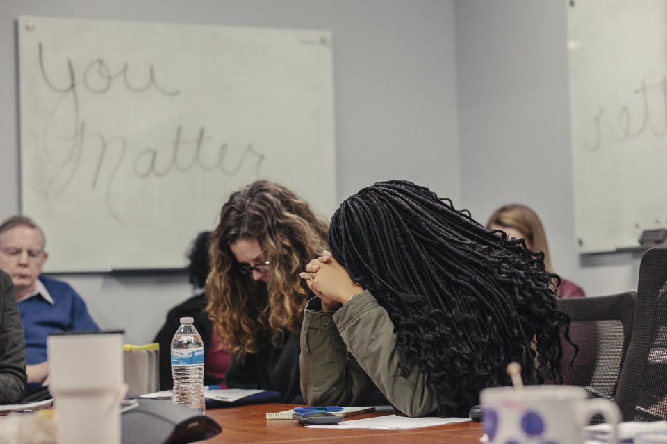 Employees at Miracle Hill Ministries pray during a meeting. The federally funded agency limits its hiring to Christians. (Photo: Jacob Biba for The Washington Post via Getty Images)