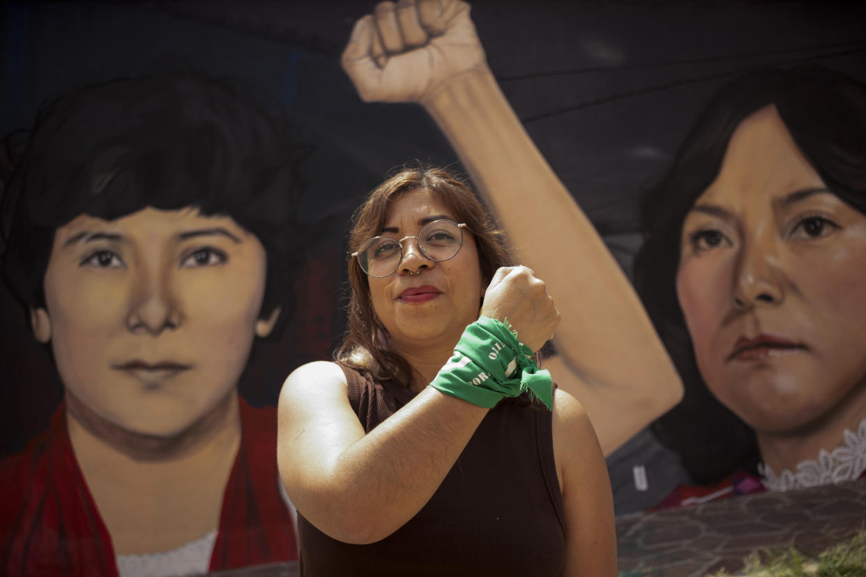Abortion rights advocate Paulina Cordoba, a member of the organization La Campamenta, poses for a photo brandishing a green bandana on her wrist, in Oaxaca, Mexico, Friday, Oct. 14, 2022. The color green has become a symbol of abortion rights around the world. (AP Photo/Maria Alferez)