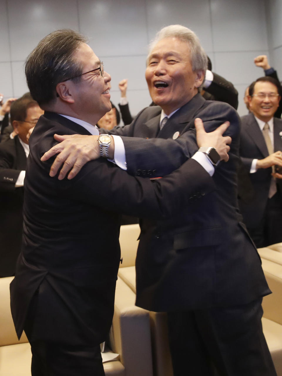 Japan's Economy, Trade and Industry Minister Hiroshige Seko,left, and head of 2025 Japan World Expo committee Sadayuki Sakakibara celebrate after winning the vote at the 164th General Assembly of the Bureau International des Expositions (BIE) in Paris, Friday, Nov. 23, 2018. Japan's Osaka will host the World Expo in 2025, beating out Russia, Azerbaijan for an event that attracts millions. (AP Photo/Christophe Ena)