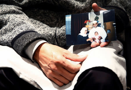 Al Noor mosque shooting survivor Farhid Ahmed poses with a photo of his wife Husna, who was killed in the attack, after an interview with Reuters in Christchurch, New Zealand March 18, 2019. Picture taken March 18, 2019. REUTERS/Edgar Su