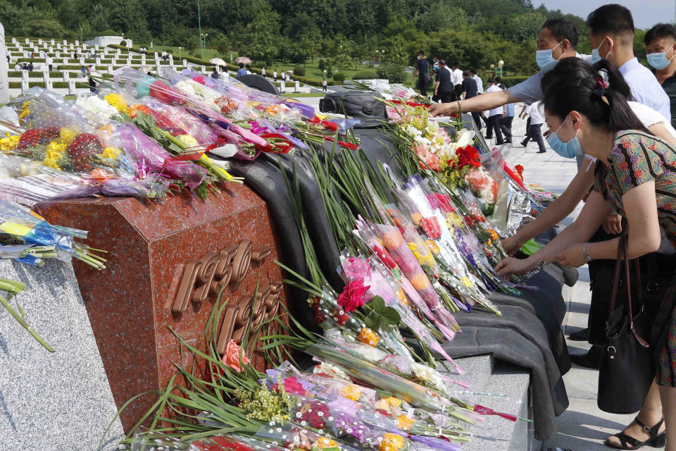 Citizens lay bouquets of flowers at the Fatherland Liberation War Martyrs Cemetery in Pyongyang, North Korea, Tuesday, July 27, 2021, to mark the Korean War armistice anniversary. The leaders of North and South Korea restored suspended communication channels between them and agreed to improve ties, both governments said Tuesday, amid a 2 ½ year-stalemate in U.S.-led diplomacy aimed at stripping North Korea of its nuclear weapons. (AP Photo/Jon Chol Jin)