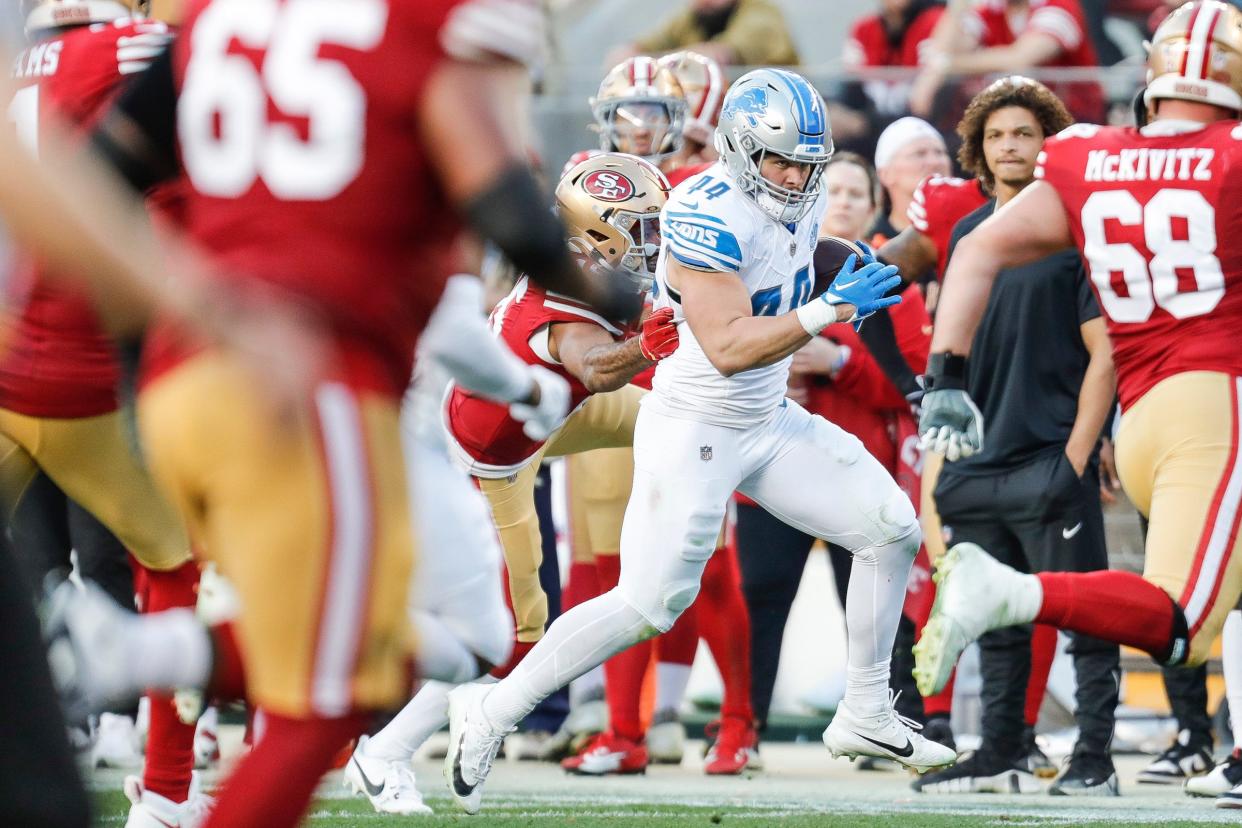 Lions linebacker Malcolm Rodriguez runs after intercepting a pass from 49ers quarterback Brock Purdy during the first half of the NFC championship game at Levi's Stadium in Santa Clara, California, on Sunday, Jan. 28, 2024.