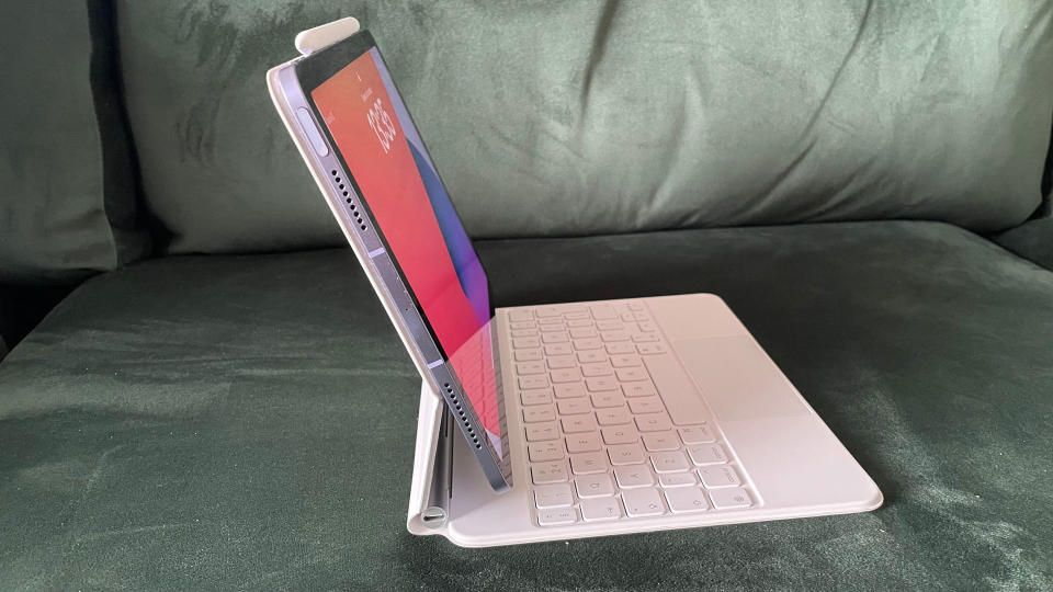 Magic Keyboard with an iPad Air in it on a dark green background