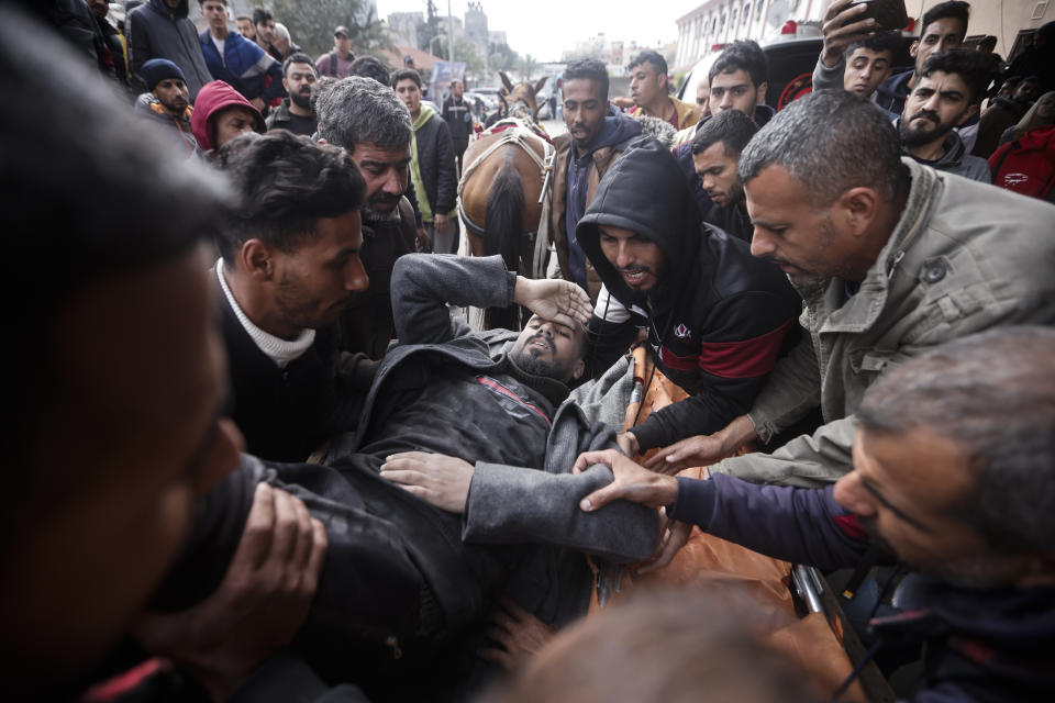 Palestinians evacuate a wounded man after an Israeli strike in Kahan Younis, Gaza Strip, Friday, Jan. 12, 2024. AP Photo/Mohammed Dahman)