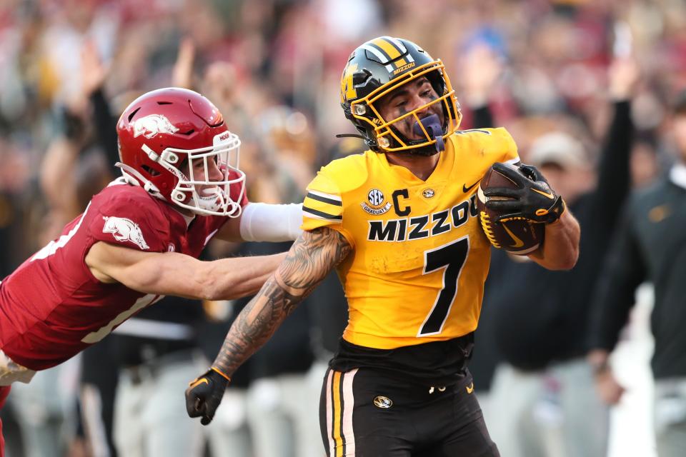 Missouri Tigers running back Cody Schrader (7) rushes against the Arkansas Razorbacks during the second quarter at Donald W. Reynolds Razorback Stadium.