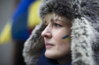 Valentina Bardakova, a demonstrator against Russian military actions in Ukraine, attends a rally near Times Square, Sunday, March 2, 2014, in New York. Western powers are prepared "to go to the hilt" to isolate Russia for its military incursion into Ukraine, "an incredible act of aggression" that may lead to visa bans, asset freezes, trade and investment penalties, and a boycott of a Russian-hosted economic summit of global powers in June, Secretary of State John Kerry said Sunday. (AP Photo/John Minchillo)