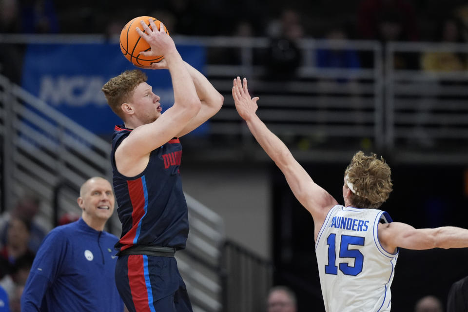 Duquesne forward Jakub Necas (7) shoots over BYU guard Richie Saunders (15) in the first half of a first-round college basketball game in the NCAA Tournament, Thursday, March 21, 2024, in Omaha, Neb. (AP Photo/Charlie Neibergall)