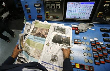 A printer checks the first copies of the inaugural Los Angeles Register newspaper as they come off the presses in Santa Ana, California April 16, 2014. REUTERS/Lucy Nicholson