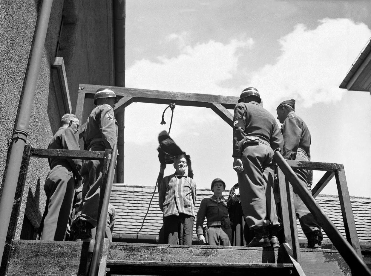 FILE - In this May 28, 1946 file photo, U.S. military authorities prepare to hang Dr. Klaus Karl Schilling, 74, at Landsberg, Germany. In a Dachau war crimes trial he was convicted of using 1,200 concentration camp prisoners for malaria experimentation. Thirty died directly from the inoculations and 300 to 400 died later from complications of the disease. His experiments all with unwilling subjects began in 1942. Germany marks the 75th anniversary of the landmark Nuremberg trials of several Nazi leaders and in what is now seen as the birthplace of a new era of international law on Friday, Nov. 20, 2020. (AP Photo/Robert Clover, file)