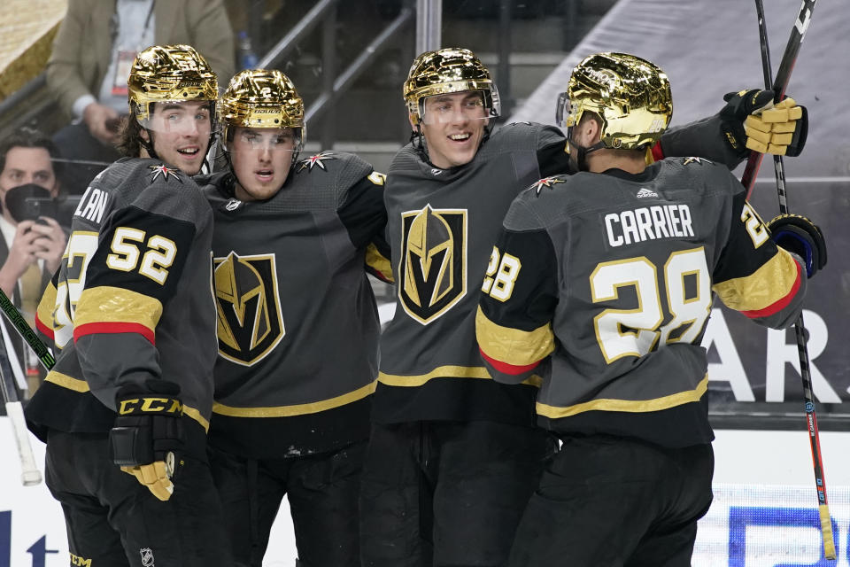 Vegas Golden Knights celebrate after left wing Tomas Nosek, second from right, scored against the Los Angeles Kings during the second period of an NHL hockey game Monday, March 29, 2021, in Las Vegas. (AP Photo/John Locher)