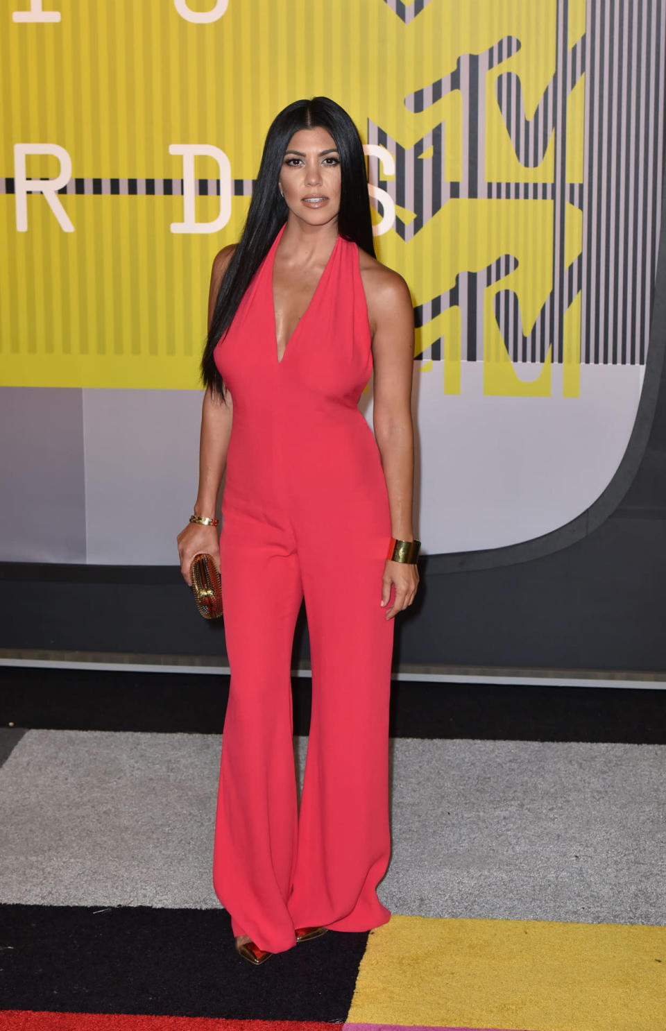Kourtney Kardashian’s hot pink jumpsuit, complete with plunging neckline, definitely showed off her fabulous mum bod, but it was slightly lacking in wow-factor. [Photo: Getty]