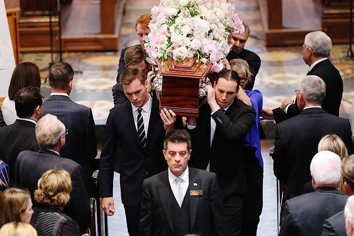 Rebecca Wilson's coffin is carried out by her sons Tom and Will Sacre. Photo: AAP