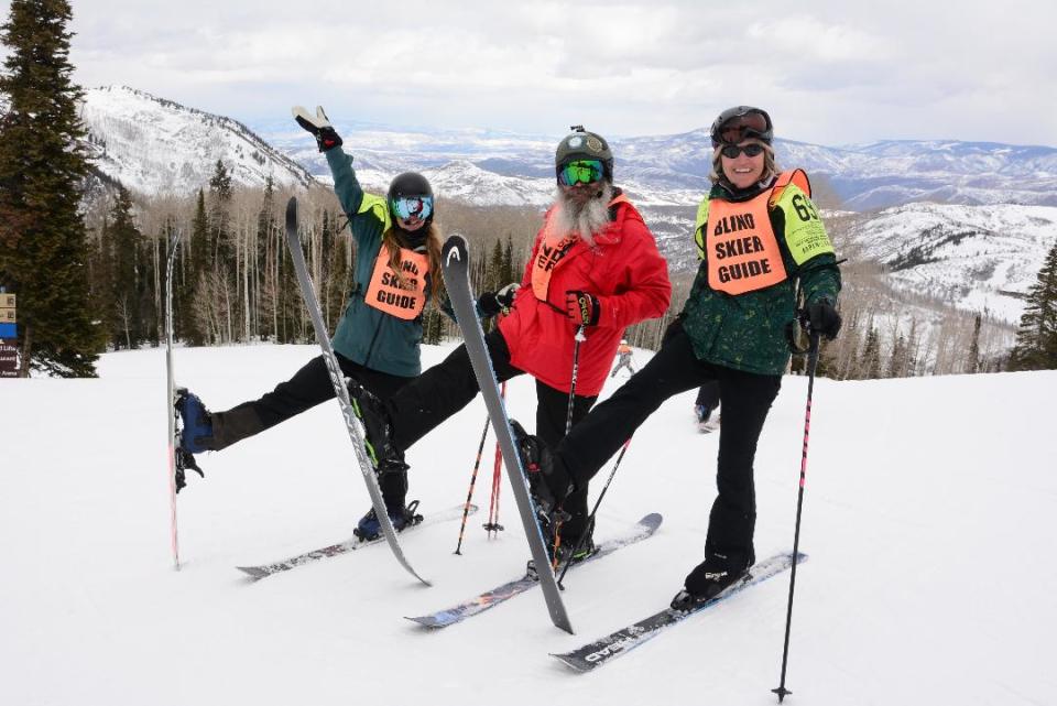 Wearing a bib that says “Blind Skier,” Gulf War Veteran Rob Sanchas, of Warren, center, is ready for a downhill run during the Winter Sports Clinic at Snowmass, Colo., in March. Guides wearing "Blind Skier Guide" bibs accompanied him down the mountain, instructing him through a headset.