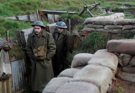 Actors Jake Morgan and Sam Ducane pose for photographs at the launch of the 1918 Poppy Pledge in a re-creation of a First World War trench at Pollock House in Glasgow, Scotland November 10, 2017. The actors appeared in the The Wipers Times, a play named after a magazine published by British soldiers in the First World War. REUTERS/Russell Cheyne