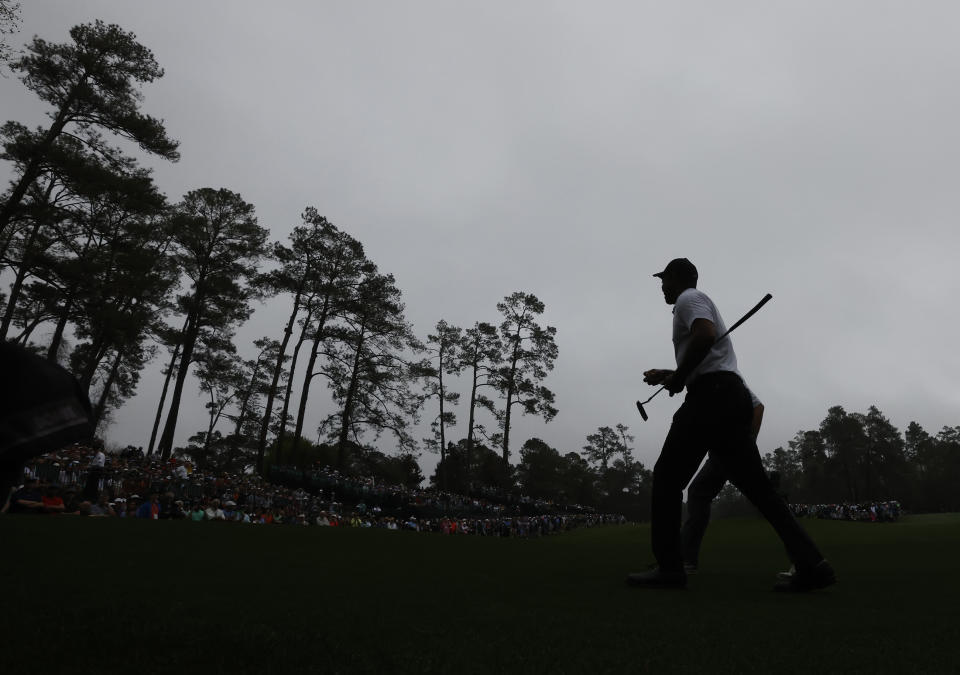 Tiger Woods walks to the 14th tee during his morning practice round for the Masters at Augusta National Golf Club in Augusta, Ga., Wednesday, April 6, 2022. (Curtis Compton/Atlanta Journal-Constitution via AP)