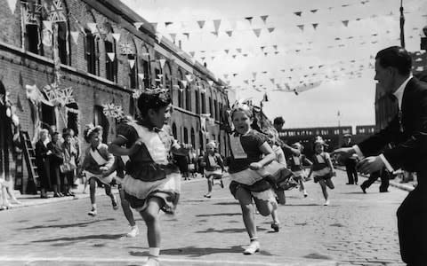 The children of Morpeth Street in London's East End enjoying a street party in celebration of the Coronation of Queen Elizabeth in 1953 - Credit: John Chillingworth/Picture Post/Getty Images