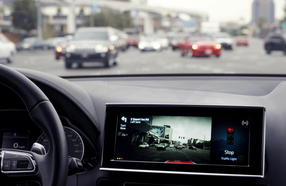 The screen in Delphi's automated vehicle shows the car stopping on its own after communicating with a stop light at an intersection at the Consumer Electronics Show in Las Vegas, January 5, 2016. Using advanced software and hardware, Delphi's vehicle can communicate with streets, signs, traffic lights, other cars and even pedestrians according to the company. REUTERS/Rick Wilking