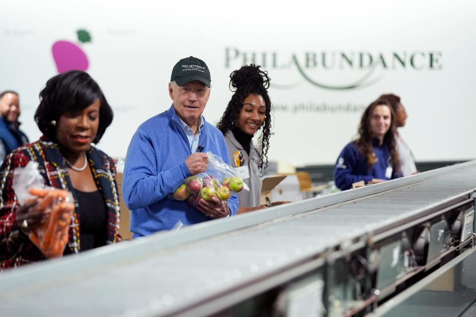 Philadelphia Mayor Cherelle Parker, left, and President Joe Biden volunteer at Philabundance, a hunger relief organization, on Jan. 15, 2024, to mark Martin Luther King Jr. Day.