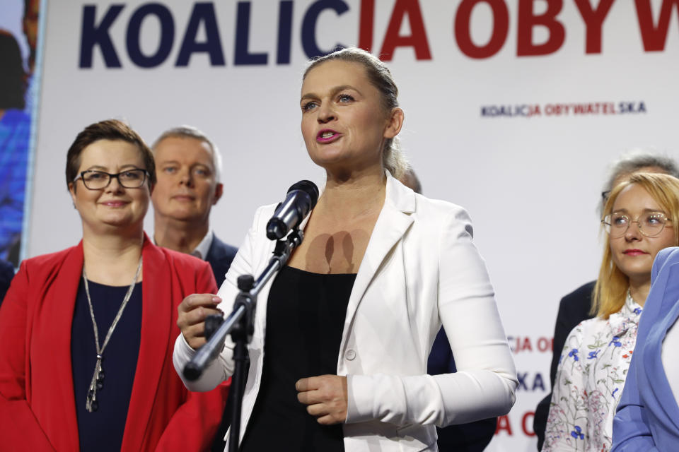 Barbara Nowacka, center, one of the leaders of opposition "Civic Coalition" addresses supporters at the coalition headquarters in Warsaw, Poland, Sunday, Oct. 13, 2019. An exit poll indicates that Poland's conservative ruling party Law and Justice has won the most votes in a general election. (AP Photo/Darko Bandic)