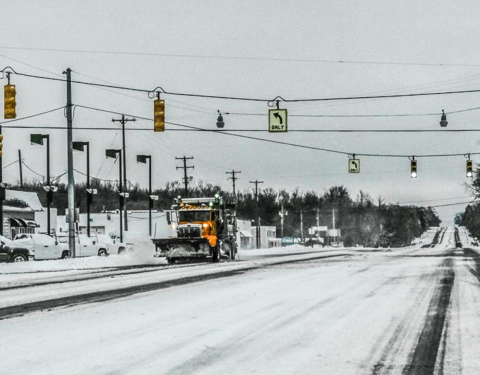 A snowplow in DeWitt works at removing the overnight snow along N. US Hwy. 27 Saturday, Jan. 17, 2020.