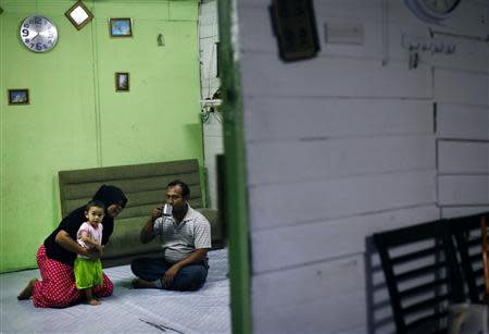 A Rohingya family rest in their rented house in Cheras Baru, Kuala Lumpur March 2, 2014. REUTERS/Samsul Said