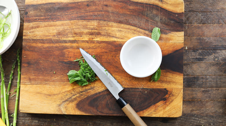 Knife slicing fresh mint