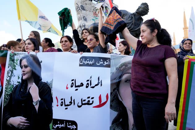 Kurdish activists in Beiruit hold headscarfs and a portrait of Iranian woman Mahsa Amini, with a sign reading: 'The woman is life, don't kill the life,' during against her death. (Photo: via Associated Press)