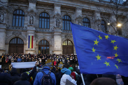 An EU flag is waved by supporters of the magistrates that protest against changes made to judicial legislation in Bucharest, Romania February 22, 2019. Inquam Photos/Octav Ganea via REUTERS