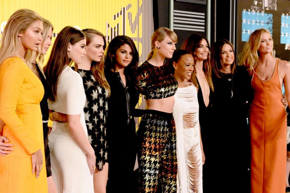 Please welcome to the stage...: Swift is flanked by (deep breath) Gigi Hadid, Martha Hunt, Hailee Steinfeld, Cara Delevingne, Selena Gomez, Serayah, Lily Aldridge, Mariska Hargitay and Karlie Kloss at the 2015 MTV VMAs (Getty)