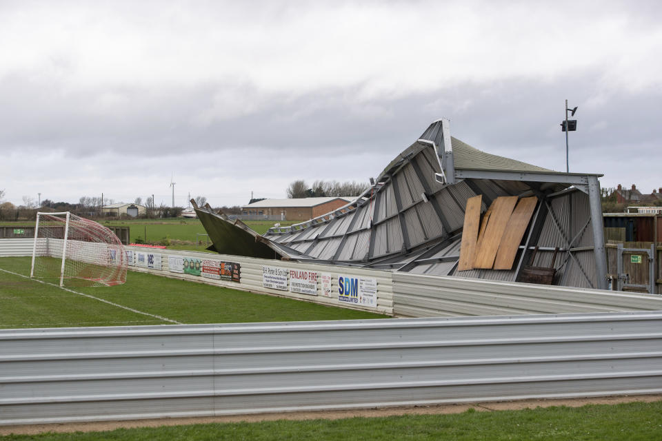 Damage to one of the stands at Wisbech Town Football Club in Cambridgeshire, England, Sunday Feb. 9, 2020. Trains, flights and ferries have been cancelled and weather warnings issued across the United Kingdom and in northern Europe as the storm with winds expected to reach hurricane levels batters the region. (Joe Giddens/PA via AP)