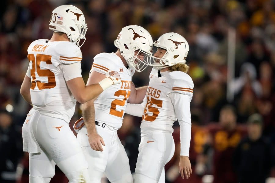 From left to right, Texas tight end Gunnar Helm and punter Ryan Sanborn congratulate place-kicker Bert Auburn on his field goal during the first half of an NCAA college football game against Iowa State, Saturday, Nov. 18, 2023, in Ames, Iowa. (AP Photo/Matthew Putney)