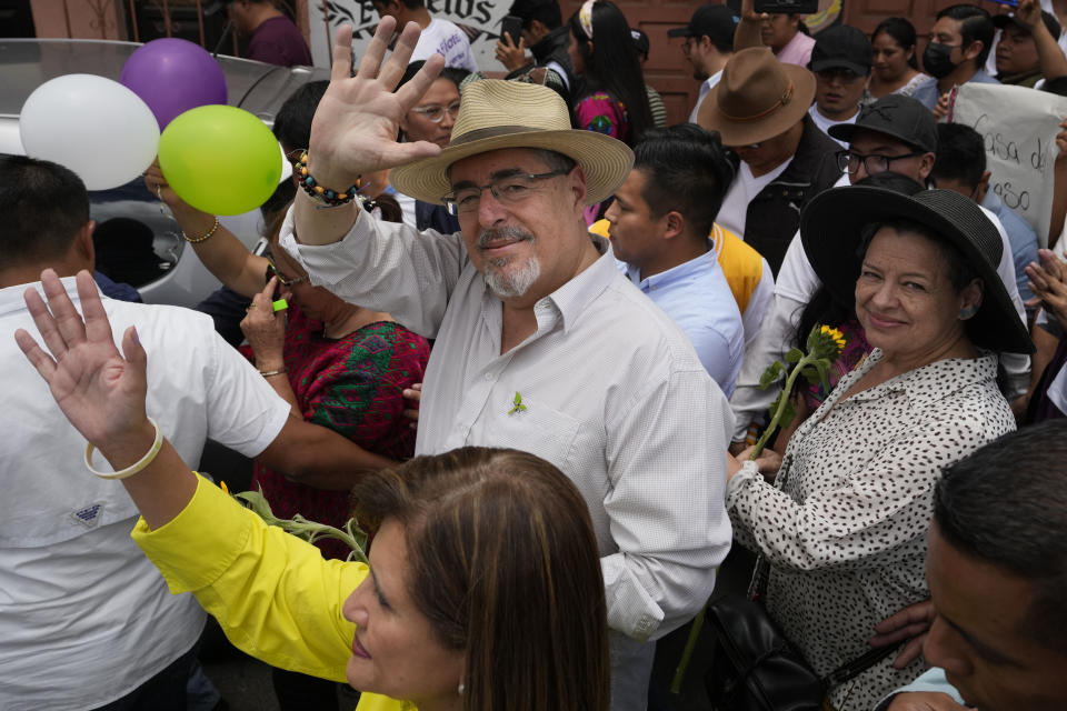 FILE - Seed Movement presidential candidate Bernardo Arevalo waves during a campaign rally in Santa Maria de Jesus, Guatemala, July 16, 2023. The 64-year-old academic and former diplomat won just 11% of the vote in the June 25th presidential election's first round, but it was enough to give him the second slot in the Aug. 20 runoff ballot. (AP Photo/Moises Castillo, File)