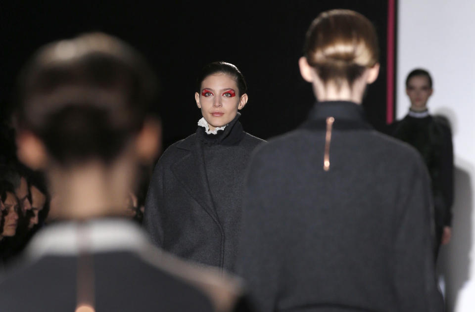 Models present creations by Belgium designer Cedric Charlier for his Ready to Wear Fall-Winter 2013-2014 fashion collection, in Paris, Tuesday, Feb.26, 2013. (AP Photo/Christophe Ena)