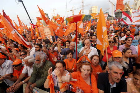 Supporters of the Free Patriotic Movement (FPM) carry flags and a broom stick during a protest in Beirut, Lebanon, September 4, 2015.REUTERS/Mohamed Azakir