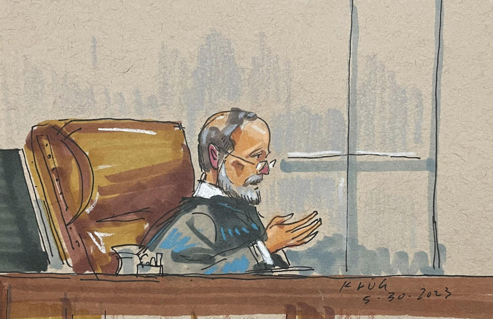 In this courtroom sketch, Judge Robert Colville presides over the federal trial for Robert Bowers, the suspect in the 2018 synagogue massacre, on Tuesday, May 30, 2023, in the downtown Pittsburgh courthouse of the U.S. District Court for Western Pennsylvania. Bowers could face the death penalty if convicted of some of the 63 counts he faces in the shootings, which claimed the lives of worshippers from three congregations who were sharing the building, Dor Hadash, New Light and Tree of Life. (David Klug via AP)