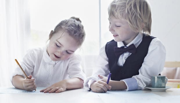 Children drawing together at table