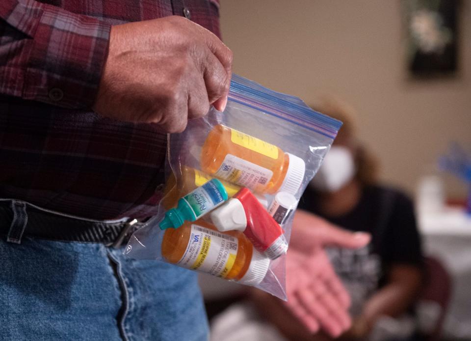 Uniontown resident Joe Williams shows the medicine he takes following the increase in waste specifically, coal ash, at the neighboring Arrowhead landfill during a community meeting in Uniontown, Ala., on Thursday, Feb. 10, 2022.