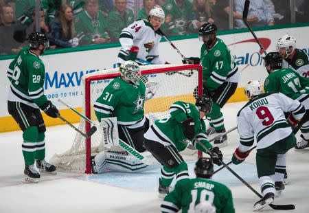 Apr 22, 2016; Dallas, TX, USA; Minnesota Wild center Mikko Koivu (9) shoots and scores a goal against Dallas Stars goalie Antti Niemi (31) to tie the game during the third period in game five of the first round of the 2016 Stanley Cup Playoffs at the American Airlines Center. Mandatory Credit: Jerome Miron-USA TODAY Sports