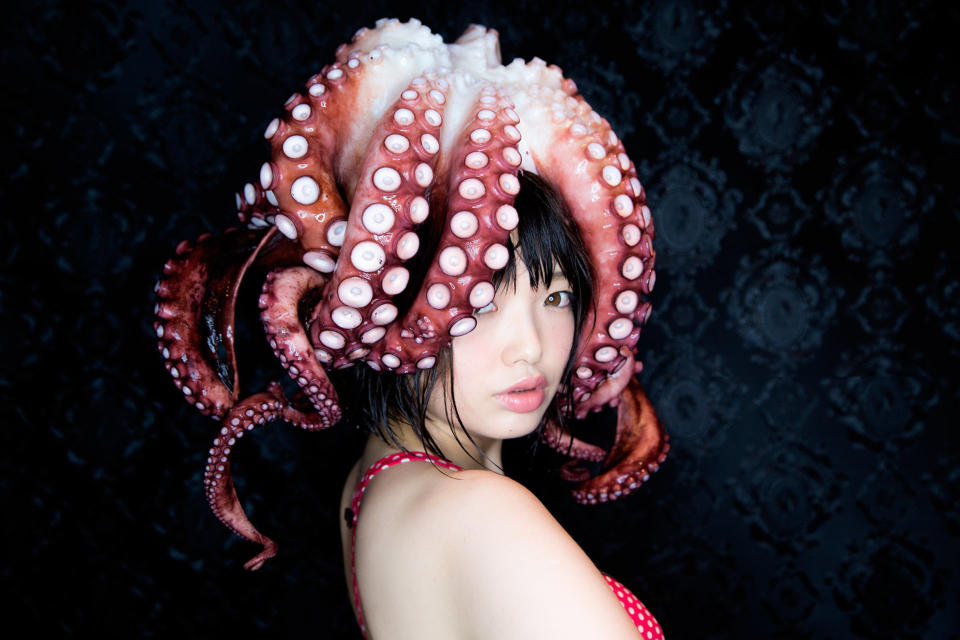 Namada and Yamamoto boiled the octopus and turned it into a hat for one last photo before eating their collaborator.